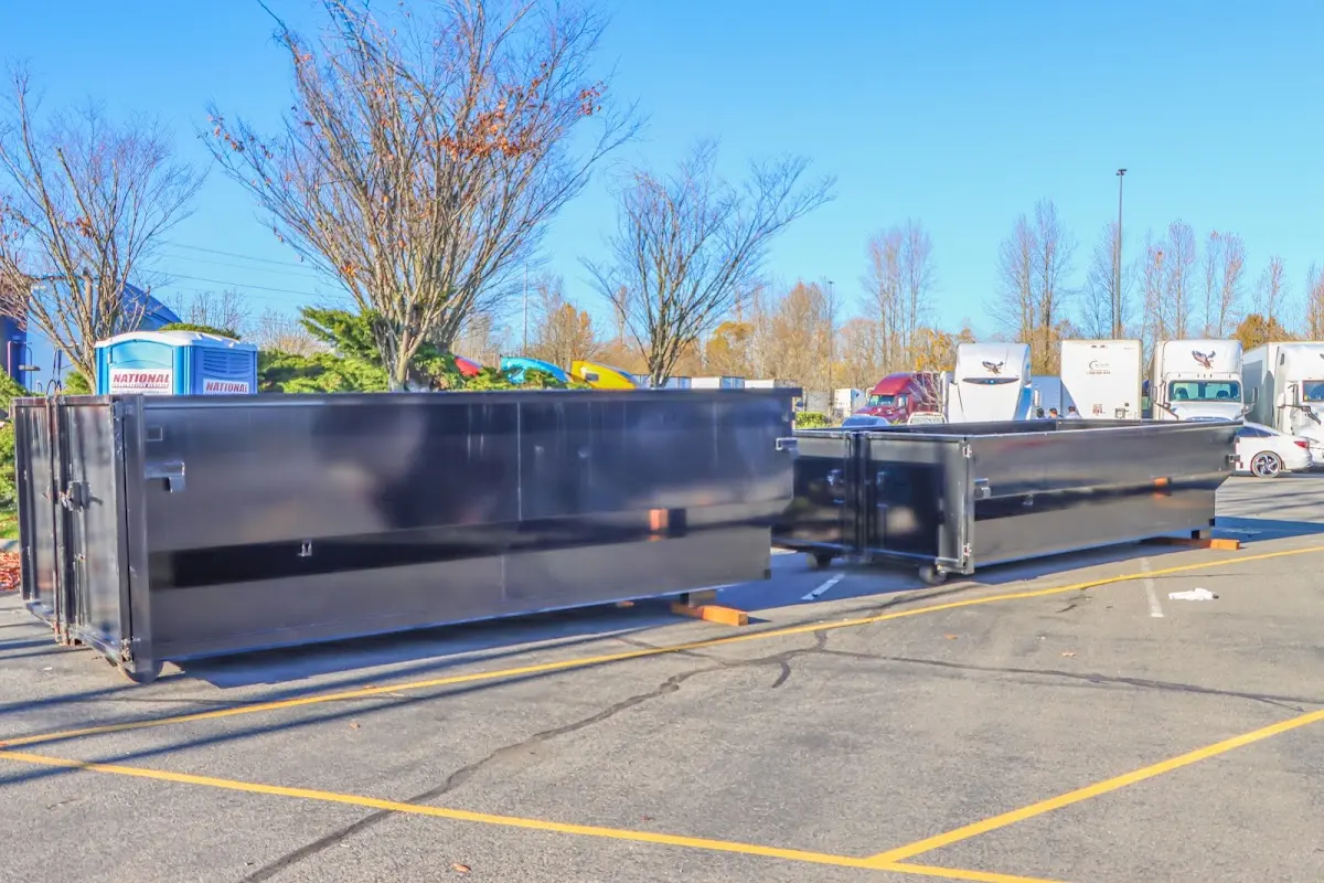 Professional dumpster rental service with roll-off container on residential driveway in Duryea